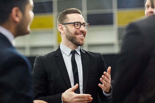 A man with a assertive personality speaks to his colleagues